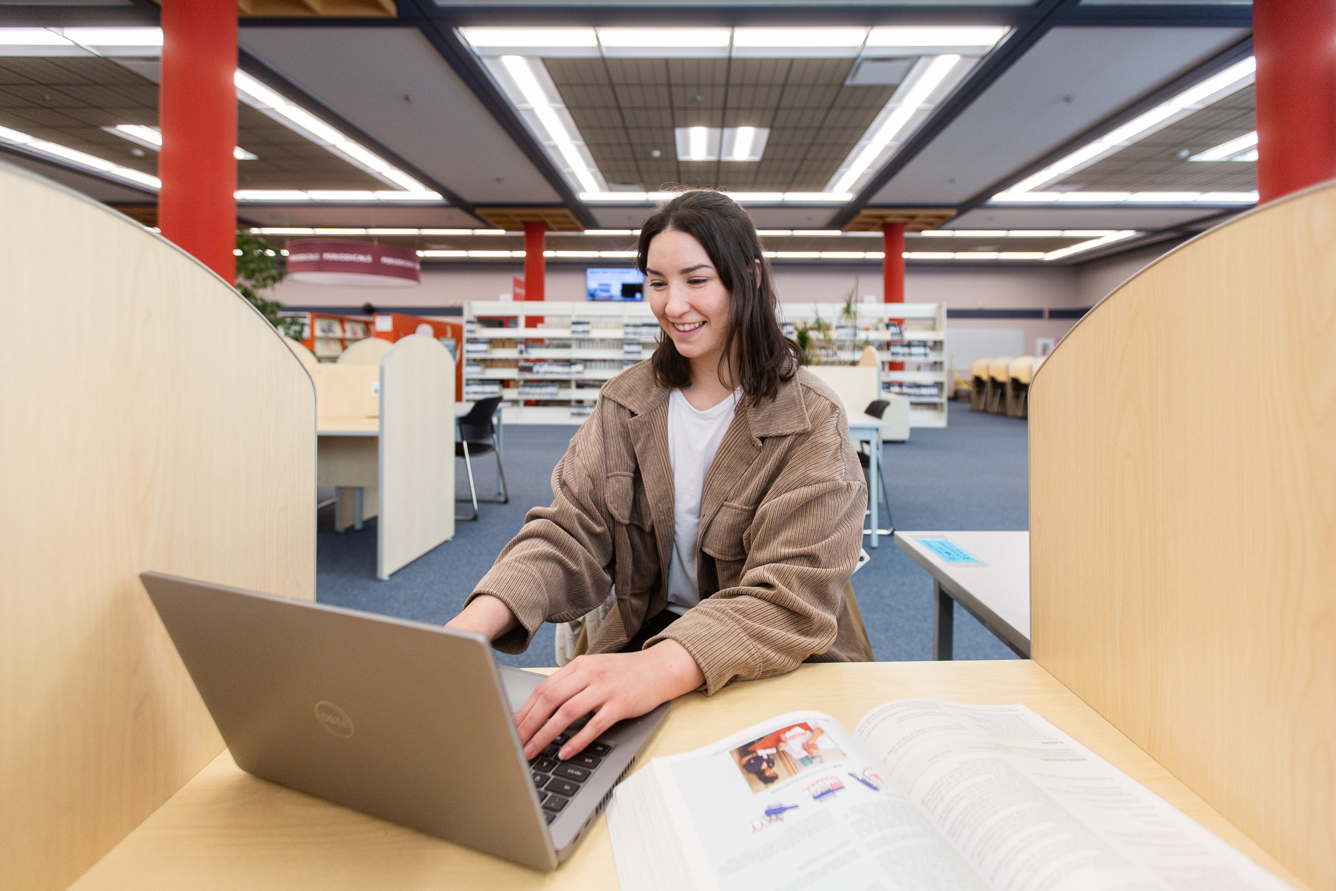 A student using her laptop in the Prince George Campus Library